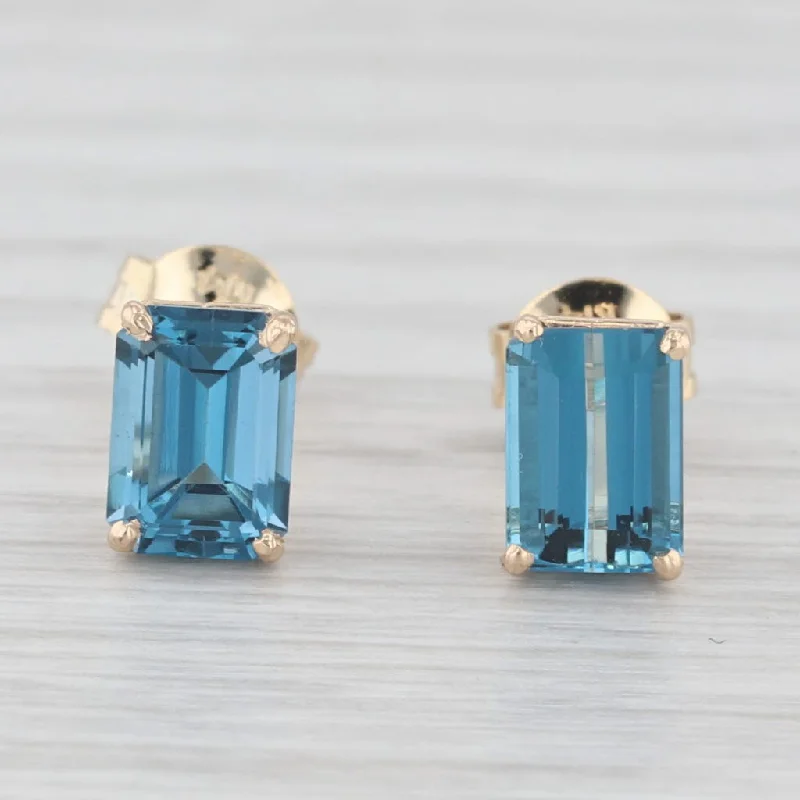 women's earrings with vibrant gemstones -2.60ctw London Blue Topaz Stud Earrings 14k Yellow Gold Emerald Cut Solitaires